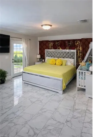 Bedroom with access to exterior and an accent wall