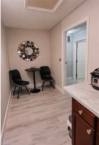 Living area featuring light wood-type flooring and baseboards