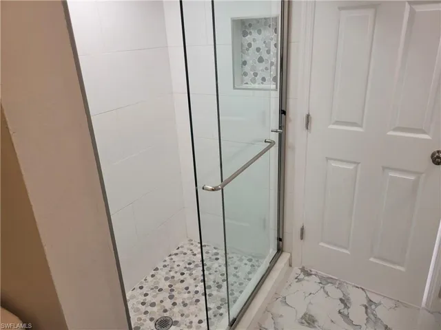 Bathroom with a shower with shower door
