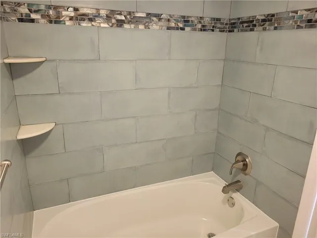 Bathroom featuring washtub / shower combination