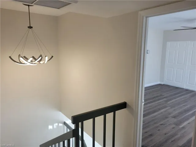 Stairway with ceiling fan and hardwood / wood-style floors