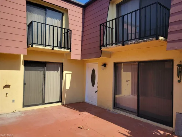 View of exterior entry with a patio