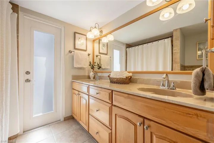 Bathroom with shower/ tub combo with pool door.