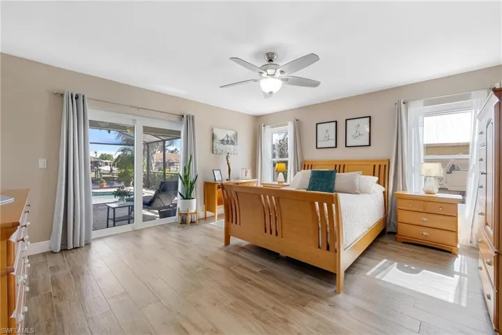 Primary bedroom with sliding glass doors to the lanai - so much sunlight!