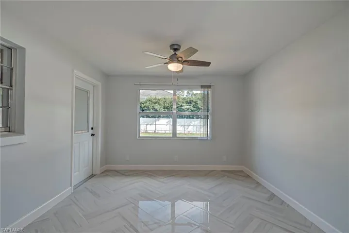 Spare room featuring baseboards and a ceiling fan