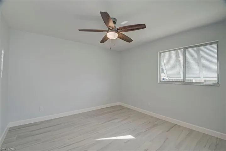 Unfurnished room with light wood-style floors and ceiling fan
