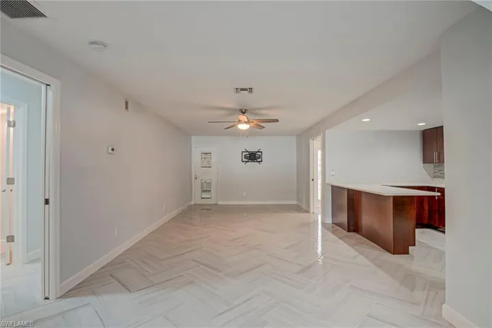 Unfurnished living room featuring a ceiling fan and recessed lighting