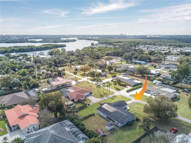 Aerial perspective of suburban area with a nearby body of water