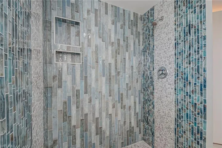 Full bath featuring tiled shower