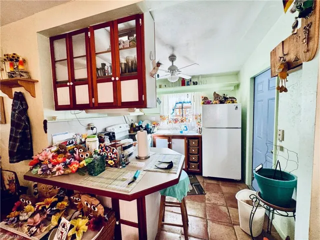 Kitchen with ceiling fan and white fridge