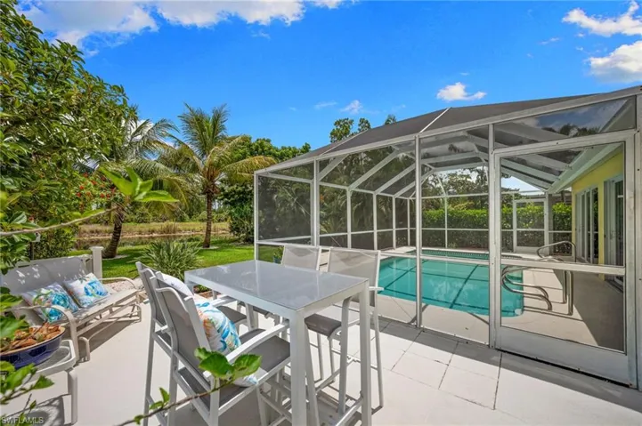 Your own private Naples retreat- screened pool, lush yard, and a home that makes going anywhere else feel unnecessary