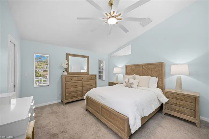 Spacious primary bedroom with vaulted ceilings and a custom wardrobe system