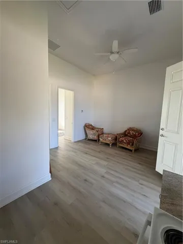 Living area featuring light wood-style flooring and ceiling fan