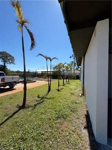 View of grassy yard with a trampoline