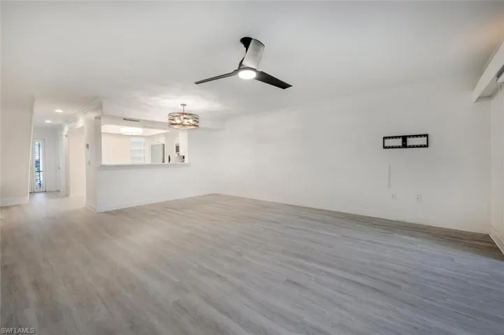 Spare room featuring ceiling fan, hardwood / wood-style flooring, and crown molding
