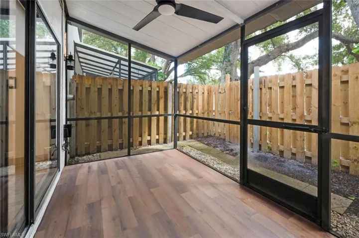 Unfurnished sunroom with vaulted ceiling, ceiling fan, and wood ceiling