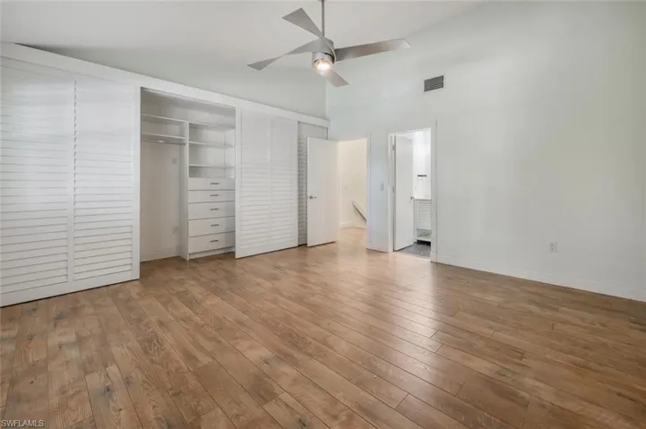 Unfurnished bedroom with hardwood / wood-style floors and ceiling fan