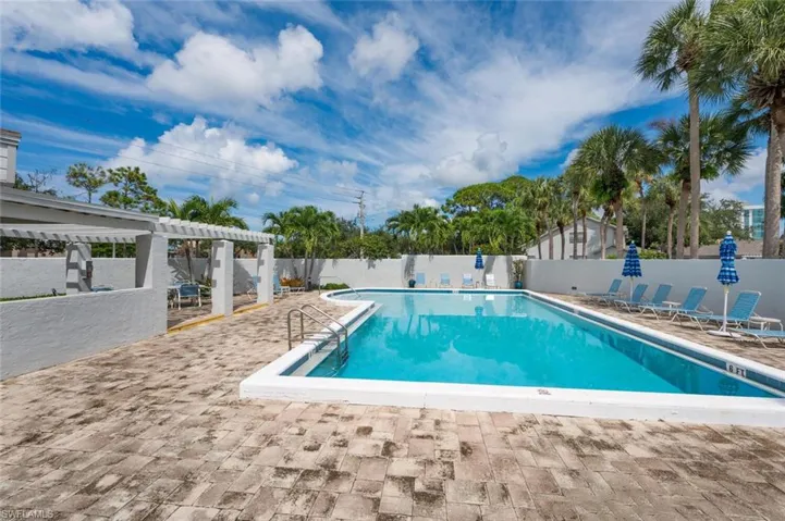 View of pool featuring a pergola and a patio area
