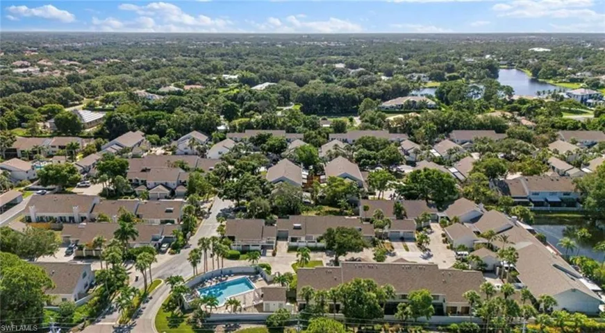 Birds eye view of property with a water view and a residential view