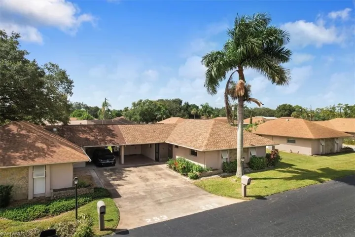 Ranch-style home with a front yard and a carport