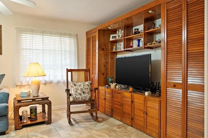 Sitting room with ceiling fan and light tile patterned floors