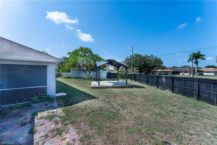 View of yard with a sunroom, a gazebo, and a patio