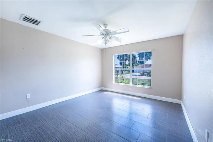 Unfurnished room featuring ceiling fan