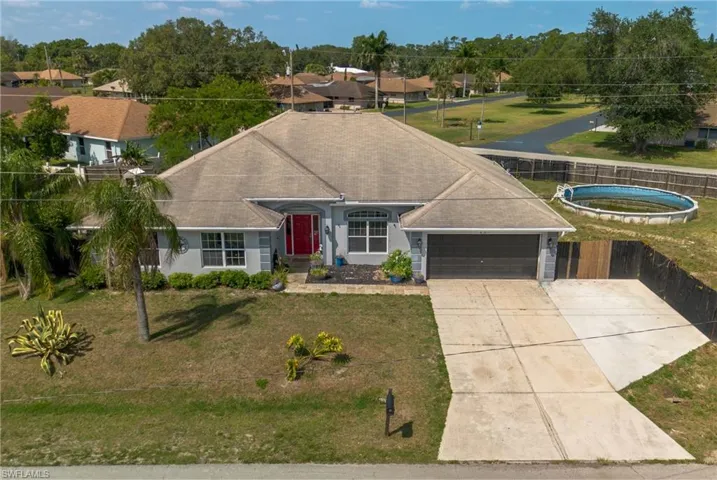 View of front of home with a garage and a front yard