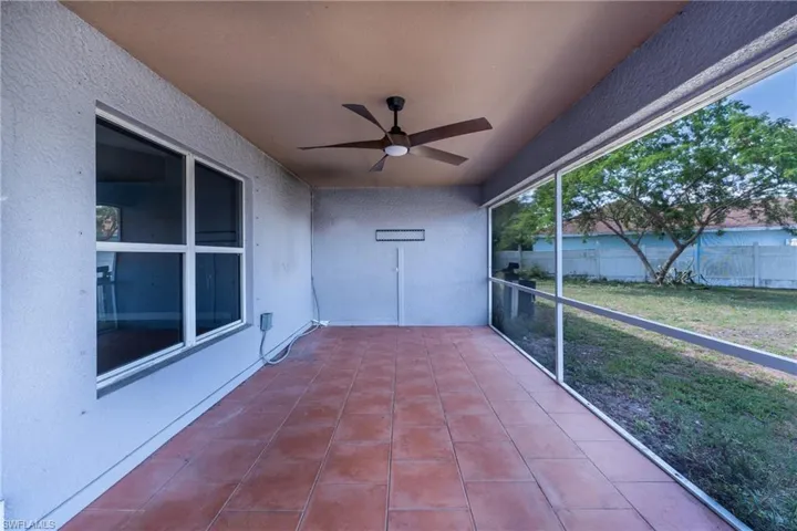 Unfurnished sunroom with ceiling fan