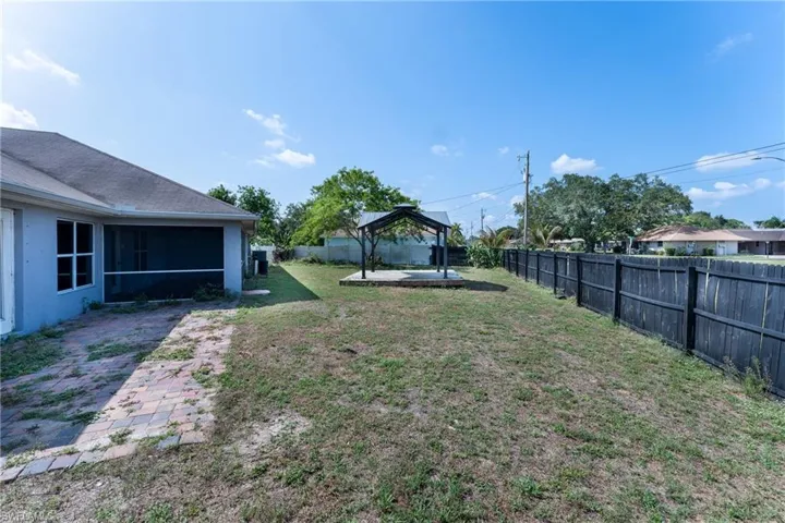 View of yard with a sunroom, a gazebo, and a patio