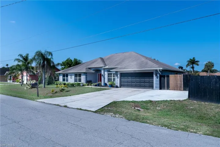 Ranch-style house with a garage and a front yard