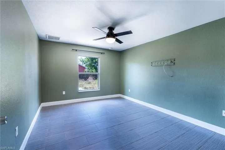 Empty room featuring ceiling fan