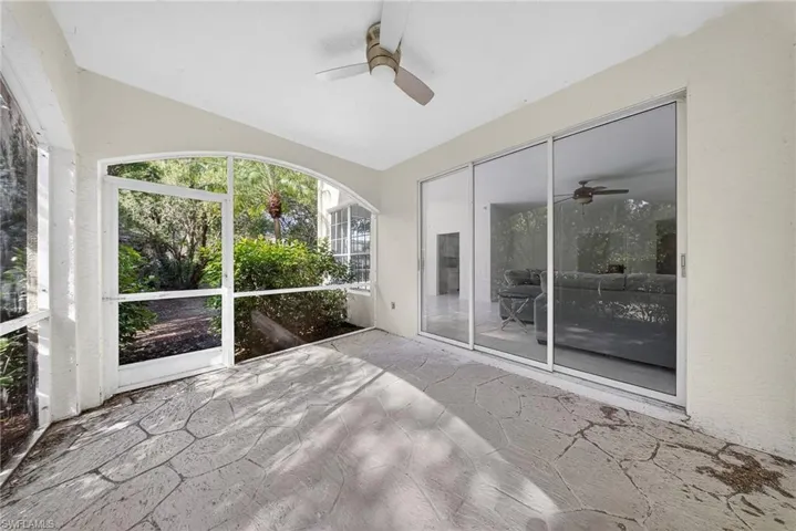 Unfurnished sunroom with ceiling fan
