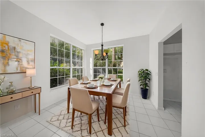 Dining room featuring hanging lights and light tile patterned floors