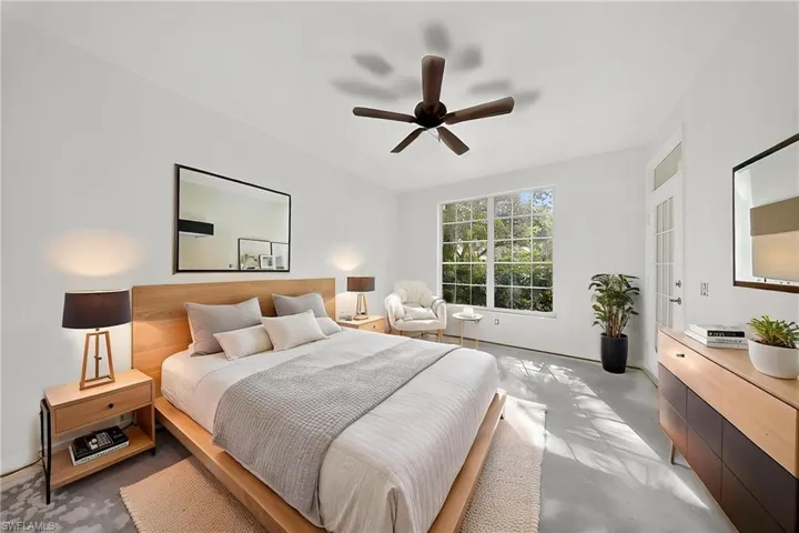 Bedroom with finished concrete floors and ceiling fan