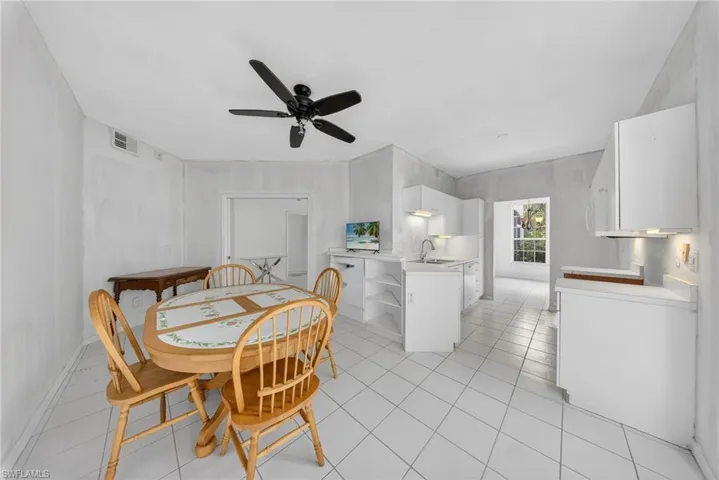 Dining area with a ceiling fan and light tile patterned floors