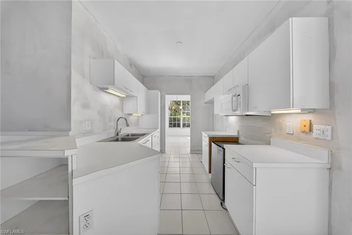 Kitchen featuring light countertops, white cabinetry, and stainless steel range