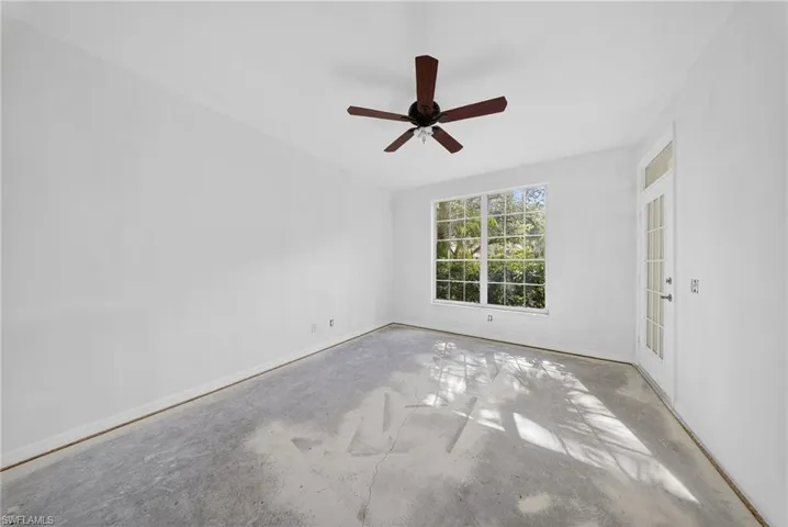 Spare room featuring concrete floors and a ceiling fan