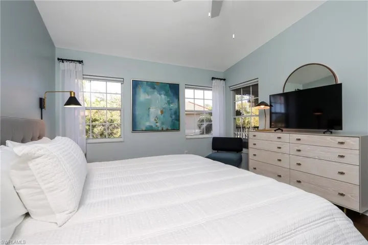 Bedroom featuring lofted ceiling, ceiling fan, and wood finished floors