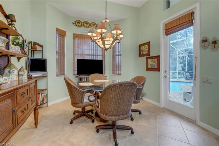 Tiled dining space with an inviting chandelier