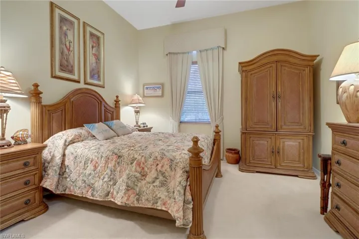 Bedroom with ceiling fan and light carpet