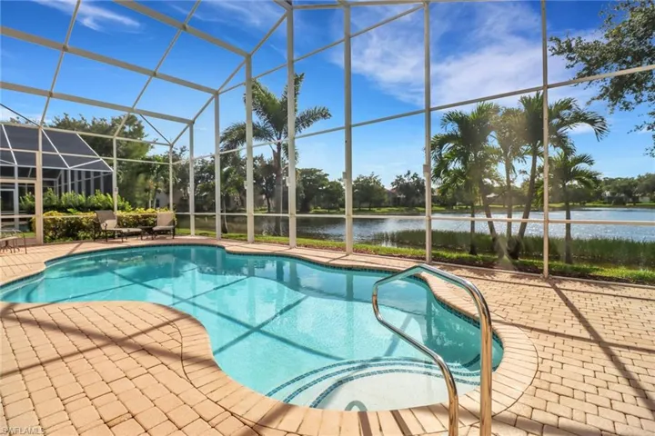 View of swimming pool with a lanai and a patio area