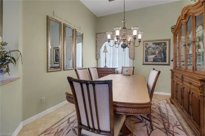 Tiled dining area featuring a chandelier