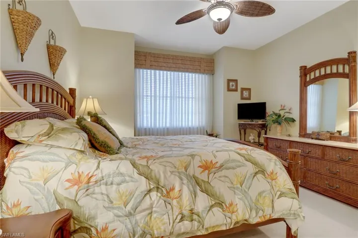 Carpeted bedroom with ceiling fan