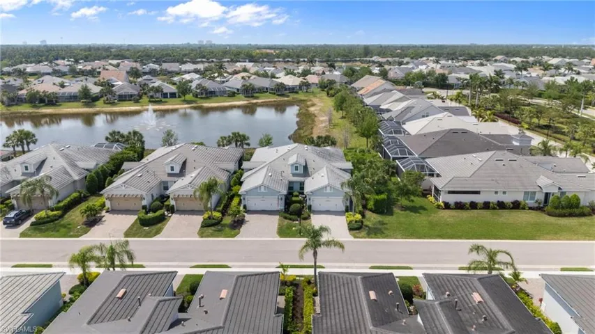 Drone / aerial view with a residential view and a water view