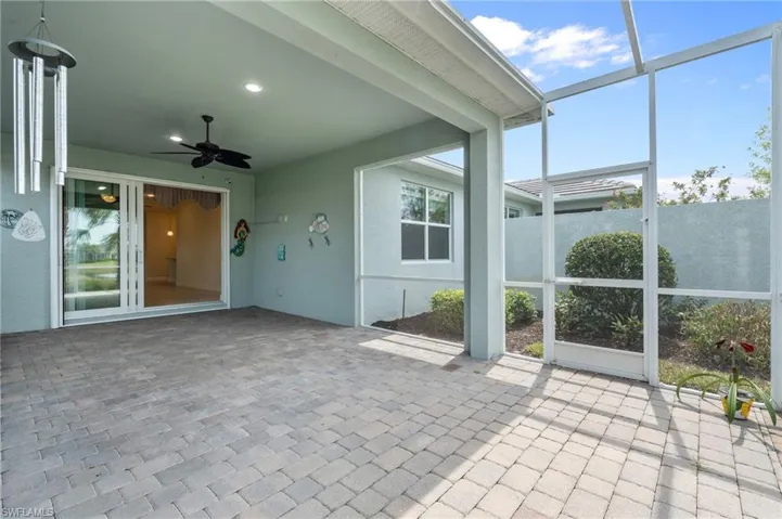 Unfurnished sunroom featuring ceiling fan and plenty of natural light