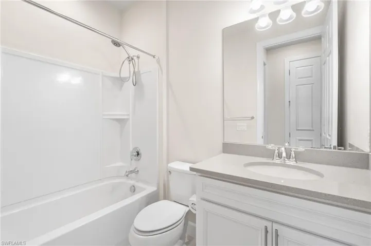 Bathroom featuring shower / tub combination, toilet, and vanity