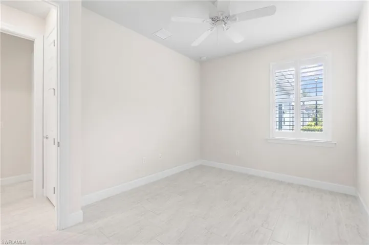 Empty room featuring visible vents, baseboards, and ceiling fan