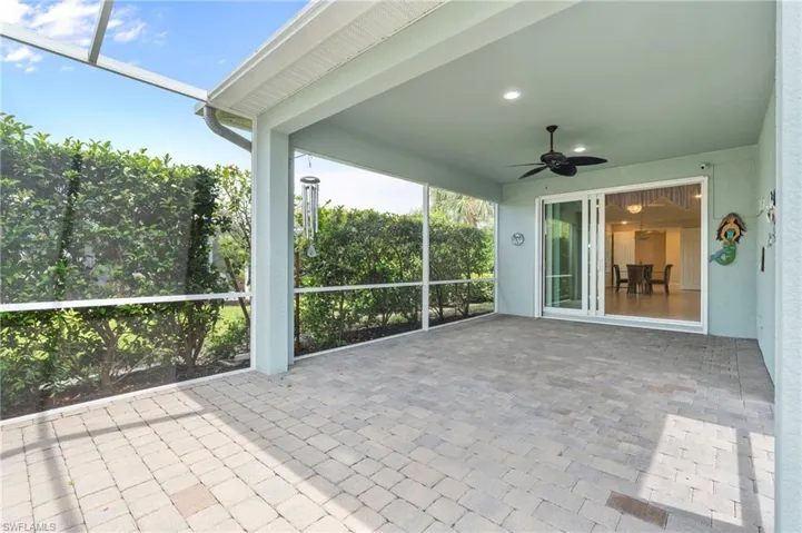 Unfurnished sunroom with ceiling fan