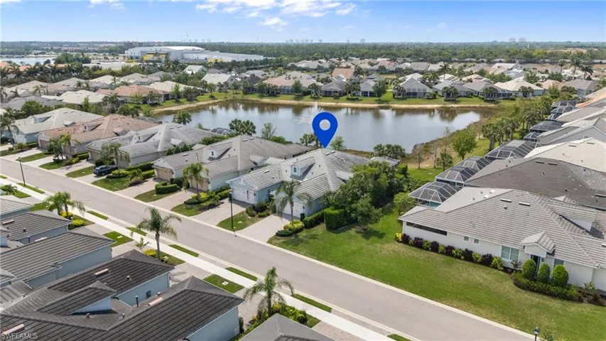 Birds eye view of property with a water view and a residential view